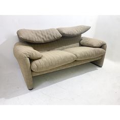 a beige couch with two pillows on it