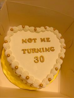 a heart shaped cake in a box that says not me turning 30