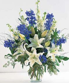 a vase filled with blue and white flowers