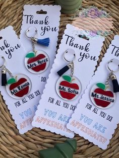 three thank you teacher keychains with an apple on them