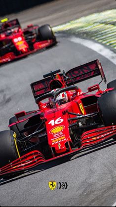 two red race cars racing on a track