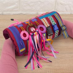 a colorful purse is sitting on the floor