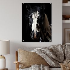 a black and white horse with long manes on it's head is shown in the living room