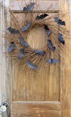 a door with a wreath made out of paper bats