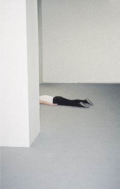 a person laying on the floor in an empty room