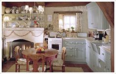 an old fashioned kitchen with white appliances and wood beams on the ceiling, along with a fireplace