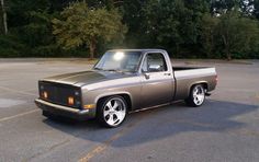 a silver truck parked in a parking lot