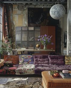 a living room filled with furniture and lots of windows