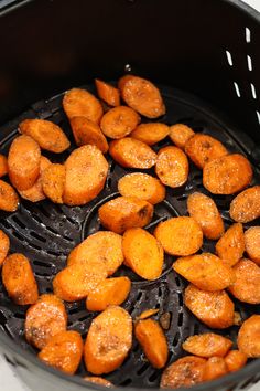 cooked carrots are being fried in an air fryer