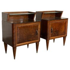 two wooden nightstands with glass tops on each side and one drawer at the top