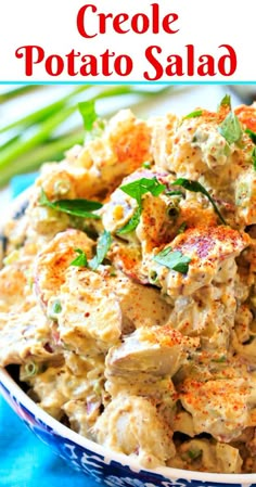 a bowl filled with potato salad on top of a blue and white table cloth next to green beans