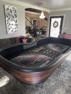 a large black table sitting in the middle of a living room