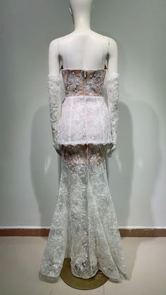 a mannequin dressed in white clothing with lace on it's shoulders and back