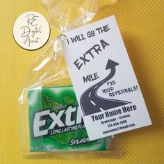 an exit sign is wrapped in plastic and sits on a yellow tablecloth next to a sticker that says, will go the extra mile