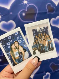 two polaroids are held up in front of a blue background with hearts