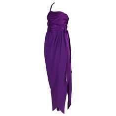 1970's Halston purple silk evening gown with a single shoulder strap and wrap skirt featuring a draped waist tie. The silk fabric which the bodice and waist tie are fabricated from is shiny silk satin while the skirt fabric is either a silk crepe de chine or silk crepe. In excellent condition with a very hard to see mark at the front bodice. No size or fabric tag - please consult measurements. MEASUREMENTS: Bust - 32" Waist - 26" Hips - 36" Skirt length - 47.5" Bodice length- 14" Halston Vintage, Purple Silk Dress, Chiffon Halter Dress, Halston Dress, Purple Evening Dress, Silk Evening Gown, Liza Minnelli, Robes Vintage, Cocktail Dress Vintage