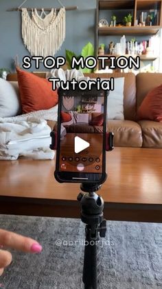 a tripod with a cell phone on it and the words stop motion in front of it