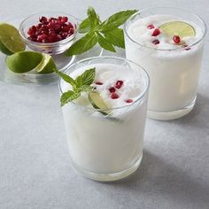 two glasses filled with ice cream and garnished with pomegranates