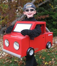 a young boy dressed up as a fire truck