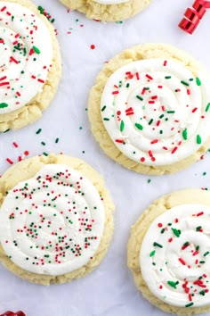 several cookies with white frosting and sprinkles