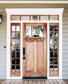 the front door to a house with two windows and wood flooring on top of it