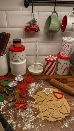 a kitchen counter topped with lots of cookies and cookie cutters on top of it