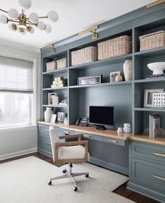 a home office with blue bookcases and white carpet