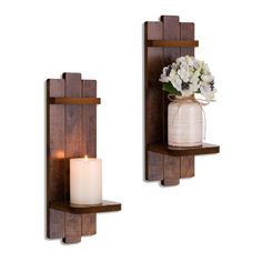 two wooden wall shelves with candles and flowers in vases next to eachother