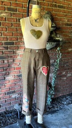 a mannequin is standing on a skateboard in front of a brick wall