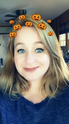 a woman with pumpkins on her head