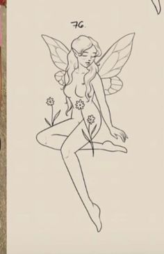 a drawing of a fairy sitting on top of a piece of paper