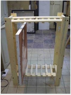 an unfinished shelf sitting on top of a tiled floor