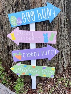 a wooden sign that says egg hunt, bunny crossing, carrot patch and jelly bean lane