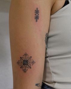 a woman's arm with a tattoo on the left side of her arm, and an ornate design on the right