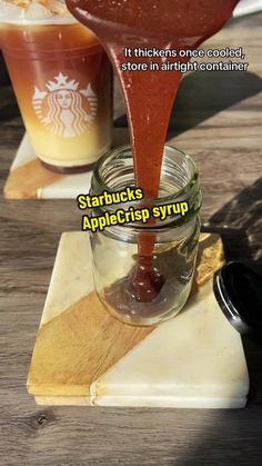 a spoon pouring starbucks coffee into a jar