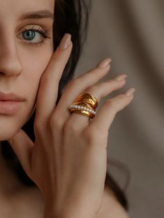 a close up of a person with a ring on their finger and her hand near her face