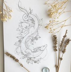 a drawing on paper with dried flowers next to it