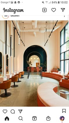 the interior of a modern restaurant with orange chairs