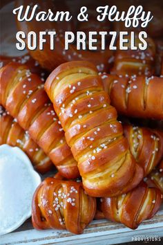 soft pretzels with sesame seeds and salt in the middle are piled on top of each other