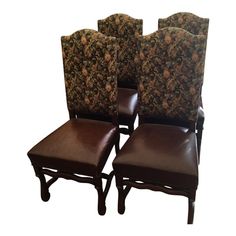 four brown leather chairs with floral upholstered back and seat covers on each side