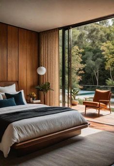 a bedroom with wood paneling and sliding glass doors leading to the outside pool area