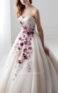 a woman in a wedding dress with flowers on it