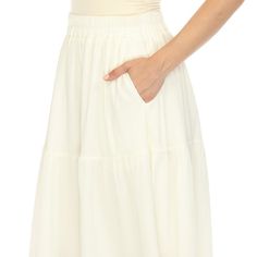 Elevate your fashion game with this flowy and effortlessly chic skirt. This maxi skirt from White Mark boasts a pleated design that adds texture, movement, and a touch of sophistication to your look. Dress it up or down as this skirt is incredibly versatile. Pair it with a tucked in blouse and heels for a sophisticated look or go for a more relaxed vibe with a tucked in tee and sandals and pair it with a jacket on chilly days. It’s perfect for various occasions and style preferences. Maxi Skirt Fall, Chic Skirt, Maxi Skirt Style, Chic Skirts, Tiered Maxi Skirt, Fall Skirts, White Mark, White Skirts, Skirt Fashion