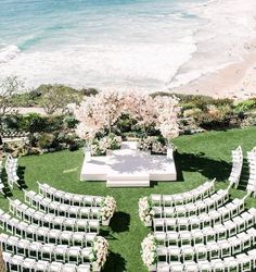 an aerial view of a wedding ceremony set up on the lawn with white chairs and flowers