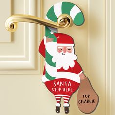 a door hanger with a santa clause holding a bag