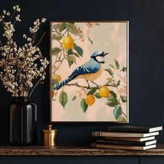 a blue bird sitting on top of a tree branch next to a vase filled with flowers