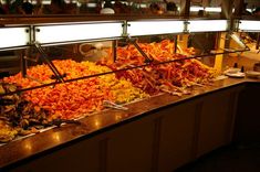 an assortment of food on display in a buffet