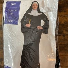 a woman in nun costume standing on top of a plastic sheet with her hands on her hips