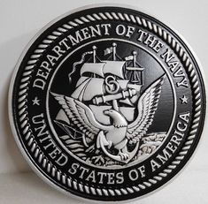 the department of the navy seal is shown on a white wall with black and silver trim