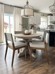 a dining room table with four chairs around it